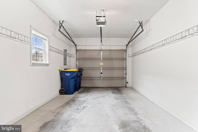 garage featuring electric panel, baseboards, and a garage door opener