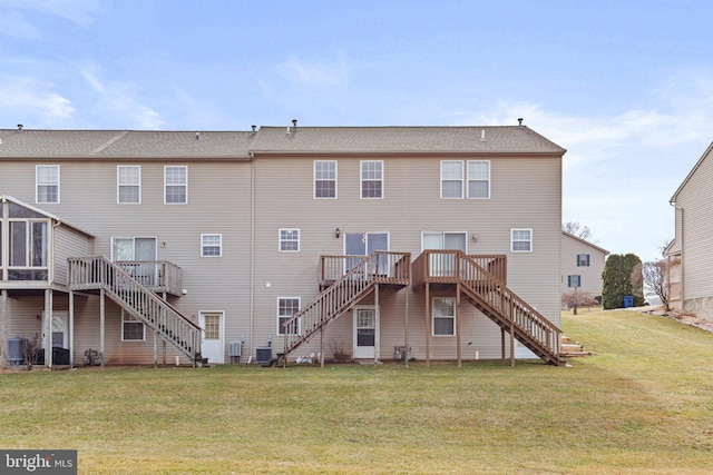 back of property with stairs, a yard, and a wooden deck