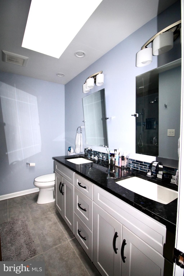 full bathroom with a sink, tile patterned floors, walk in shower, and toilet