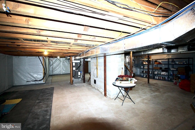 unfinished basement featuring heating unit