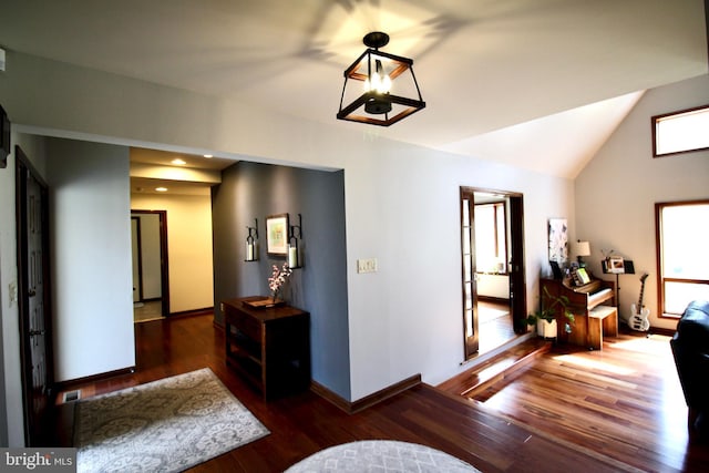 corridor with visible vents, vaulted ceiling, wood finished floors, baseboards, and recessed lighting