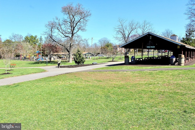 view of property's community with a yard, driveway, a gazebo, and a carport