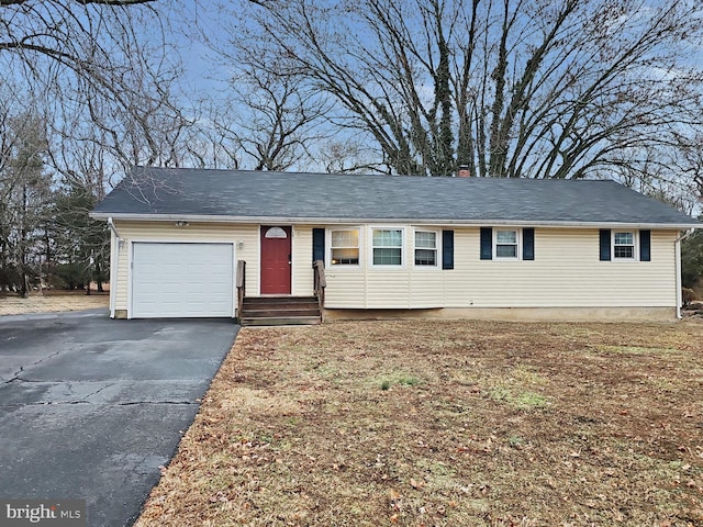 ranch-style house with driveway and an attached garage