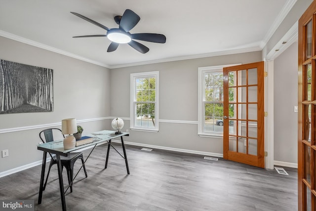 office space featuring a healthy amount of sunlight, visible vents, and ornamental molding