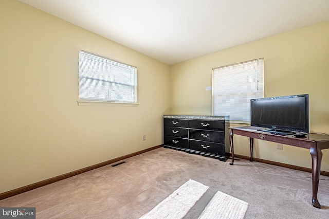 bedroom with visible vents, light colored carpet, and baseboards