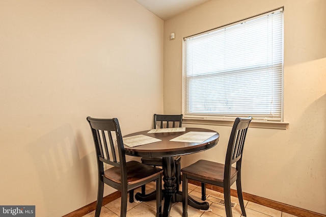 dining space with light tile patterned floors and baseboards