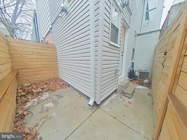 view of side of property with a patio and cooling unit