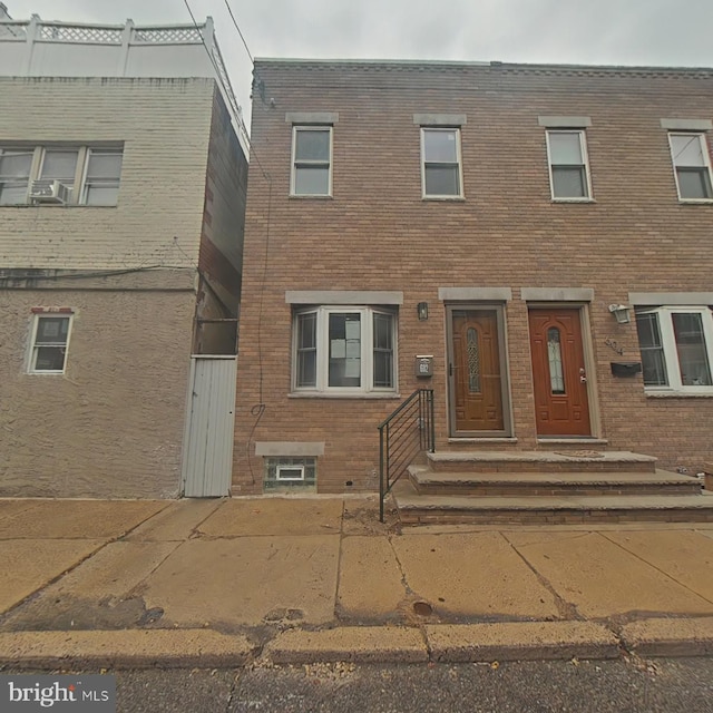 townhome / multi-family property featuring brick siding