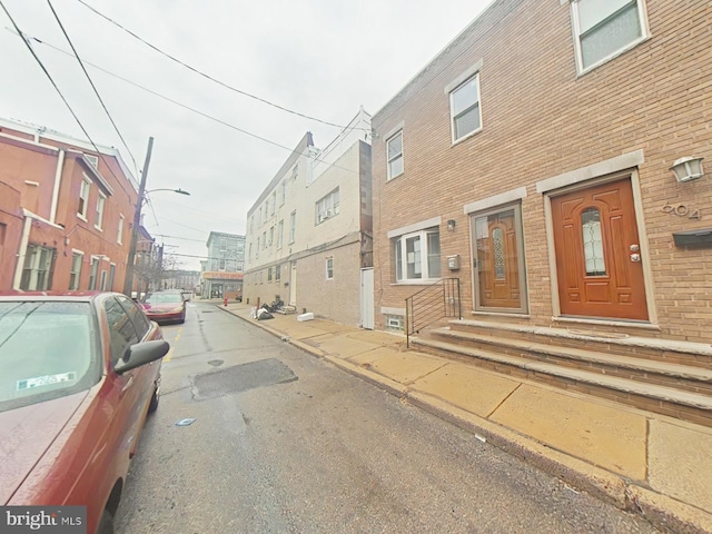 view of road with sidewalks, street lighting, and curbs