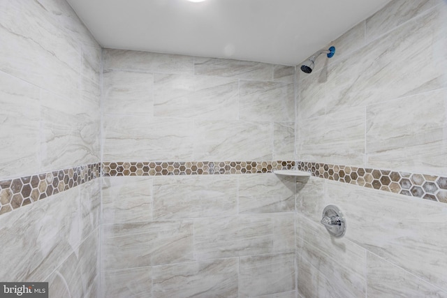 bathroom with a tile shower