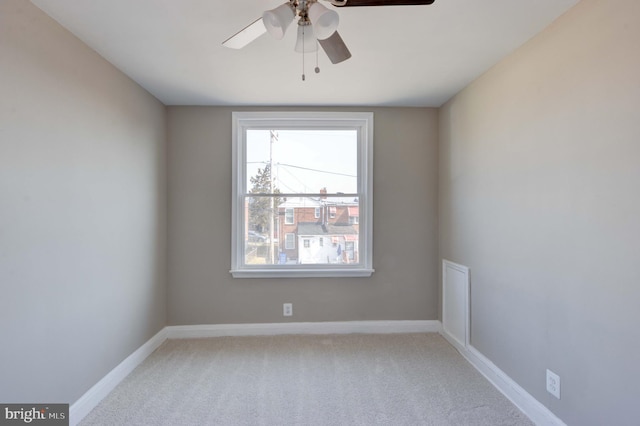 empty room with ceiling fan, baseboards, and light colored carpet