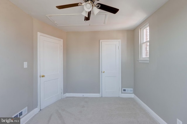 unfurnished bedroom with carpet, visible vents, and baseboards