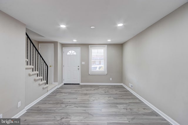 entrance foyer featuring stairs, baseboards, wood finished floors, and recessed lighting