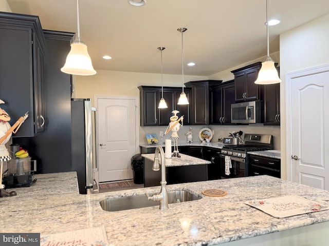 kitchen featuring a sink, decorative backsplash, light stone countertops, and stainless steel appliances