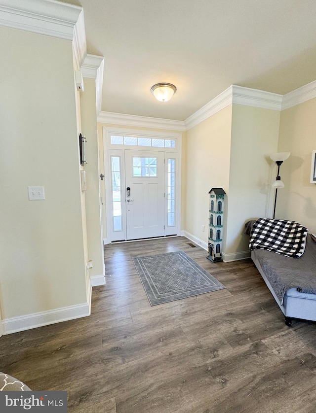 entryway featuring crown molding, wood finished floors, and baseboards