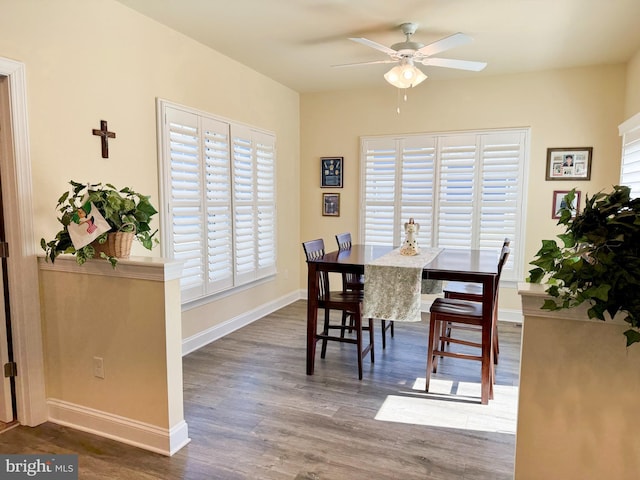 dining room featuring ceiling fan, baseboards, and wood finished floors