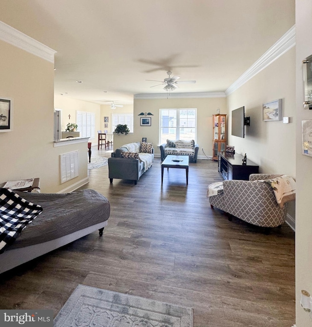 living area featuring ceiling fan, visible vents, wood finished floors, and crown molding