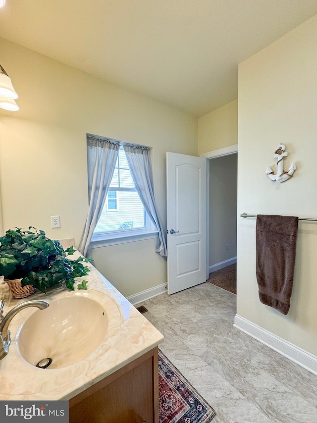 bathroom featuring vanity and baseboards