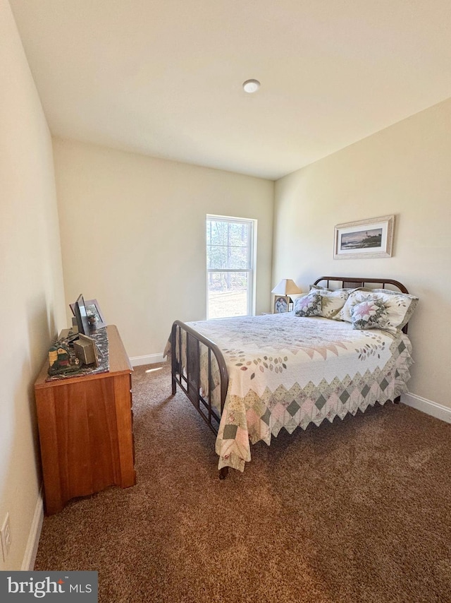 bedroom with baseboards and carpet