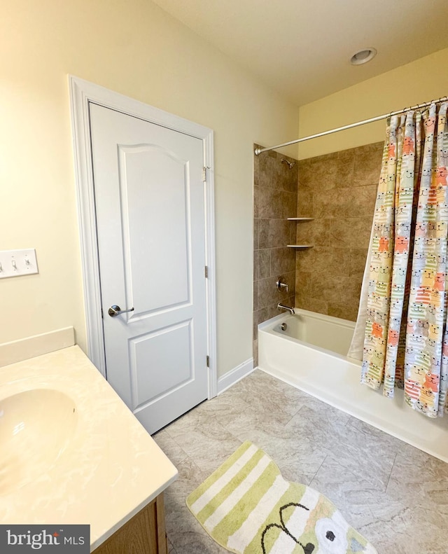 full bath featuring vanity, shower / bath combo, and tile patterned flooring