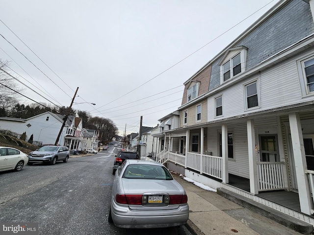 view of street with sidewalks, a residential view, and street lights