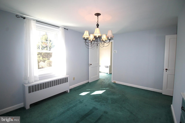 carpeted spare room featuring radiator, baseboards, and a notable chandelier