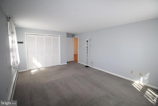 unfurnished bedroom with baseboards, a baseboard heating unit, and a closet