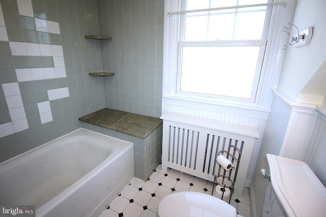 bathroom with a wainscoted wall and toilet