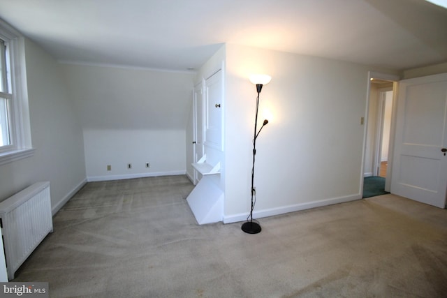 bonus room featuring radiator, carpet flooring, and baseboards