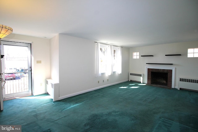 unfurnished living room with carpet, radiator, baseboards, and a brick fireplace