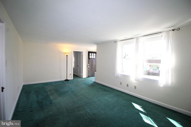 empty room with carpet and baseboards