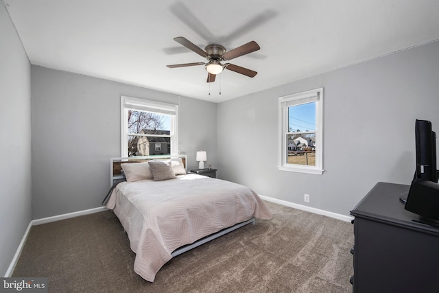 carpeted bedroom featuring ceiling fan and baseboards