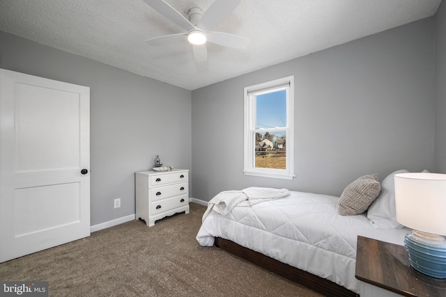 bedroom featuring ceiling fan, a textured ceiling, baseboards, and carpet floors