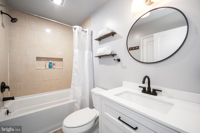 bathroom featuring vanity, toilet, visible vents, and shower / bath combo