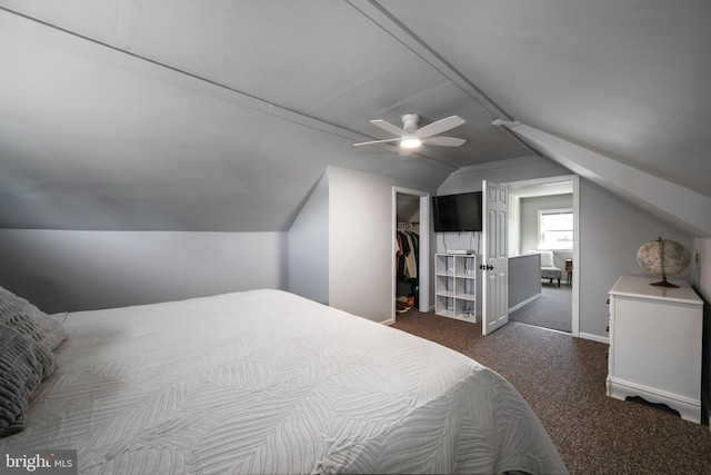 bedroom featuring a ceiling fan, carpet, vaulted ceiling, a spacious closet, and a closet