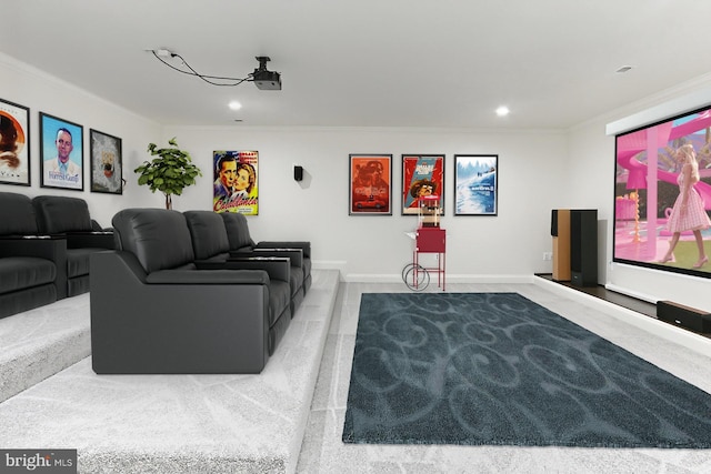 carpeted home theater room featuring baseboards, ornamental molding, and recessed lighting