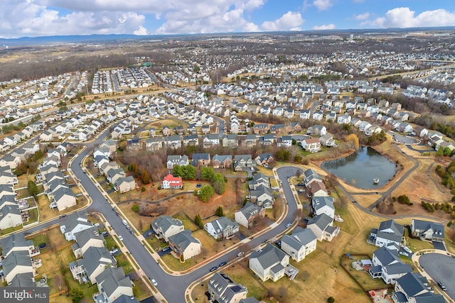 drone / aerial view featuring a water view and a residential view