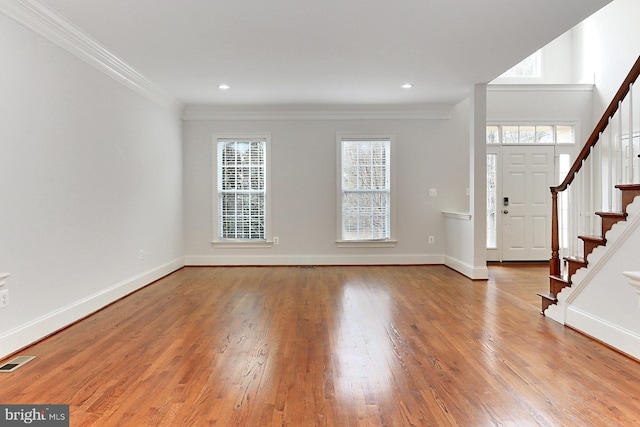 entryway with visible vents, baseboards, stairway, wood finished floors, and crown molding