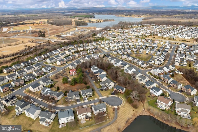 birds eye view of property featuring a water view and a residential view