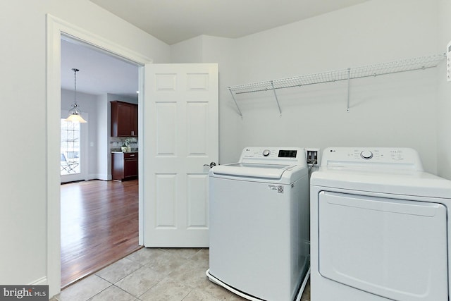 laundry area featuring light tile patterned floors, laundry area, and independent washer and dryer