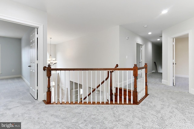 hallway with baseboards, carpet flooring, an upstairs landing, and recessed lighting