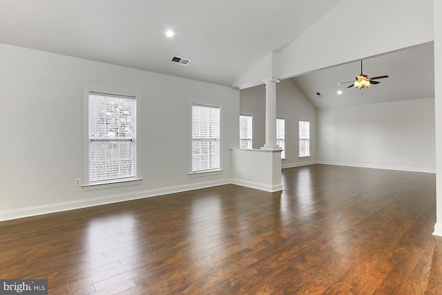 unfurnished living room with decorative columns, visible vents, baseboards, a ceiling fan, and dark wood-type flooring