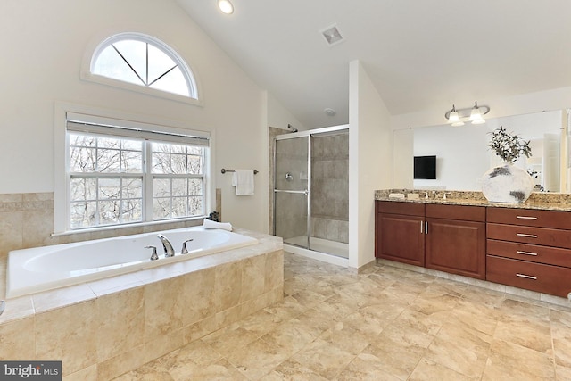 bathroom featuring a stall shower, visible vents, a garden tub, vanity, and high vaulted ceiling