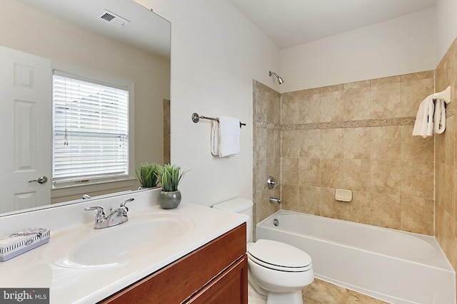 bathroom with toilet, shower / bathtub combination, visible vents, and vanity