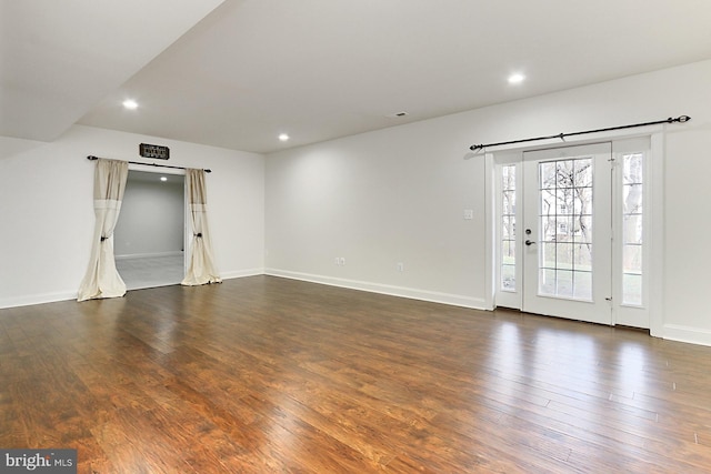 spare room featuring dark wood-style floors, visible vents, baseboards, and recessed lighting