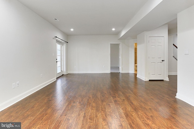 spare room with dark wood-type flooring, stairway, recessed lighting, and baseboards