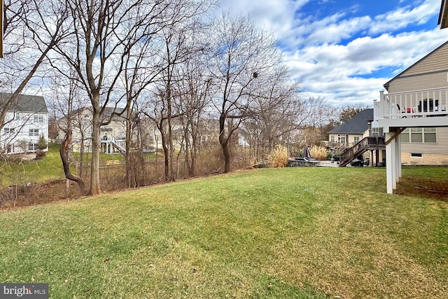 view of yard with stairway and a wooden deck