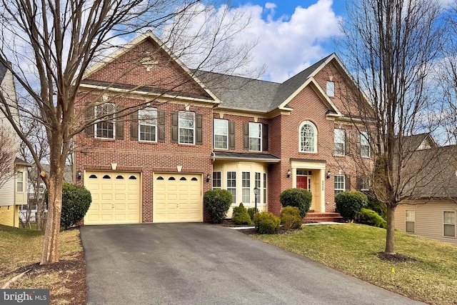 view of front facade featuring a garage, brick siding, driveway, roof with shingles, and a front lawn