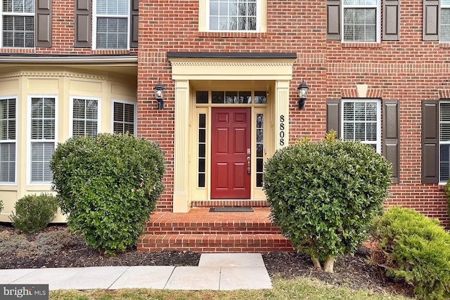 property entrance with brick siding