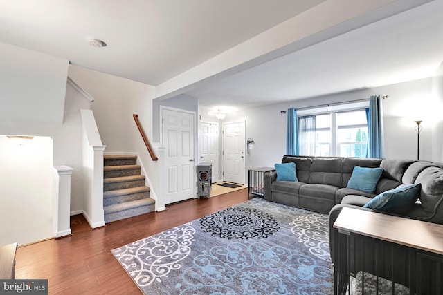 living room with stairway, baseboards, and wood finished floors